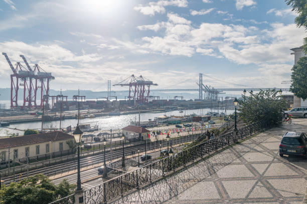 Lisbon, Portugal - December 4, 2022: Liscont container terminal and 25 de Abril Bridge.