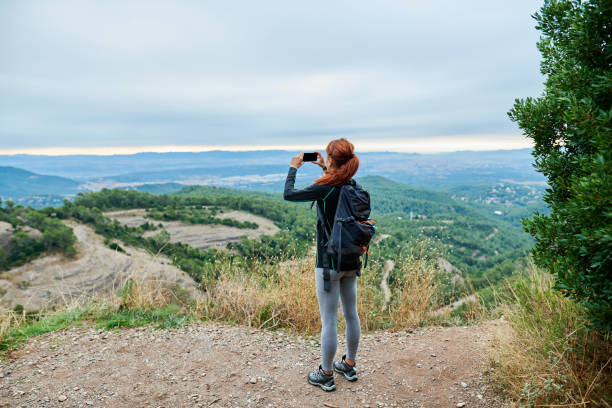 istock Redhead taking a photo of the view 1473949575