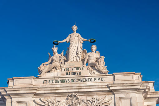 Lisbon, Portugal - December 6, 2022: Sculptures on the top of Triumph Arch in Rua Augusta.