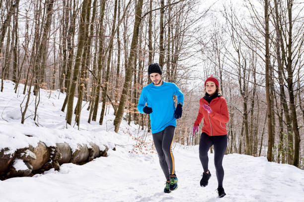 istock Couple running in winter forest 1473950835