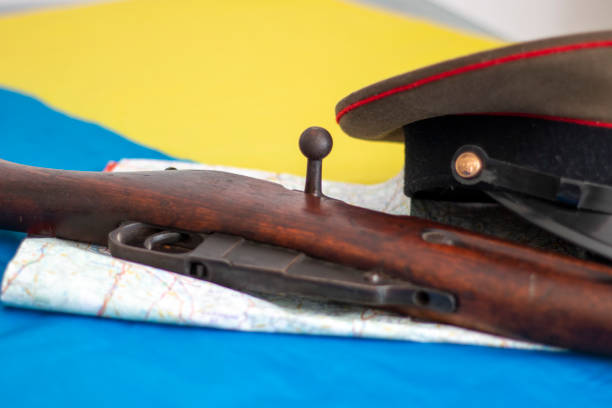 istock Ukraine flag with different military objects such as a rifle, a Russian military hat, a map or a police defense 1473952823
