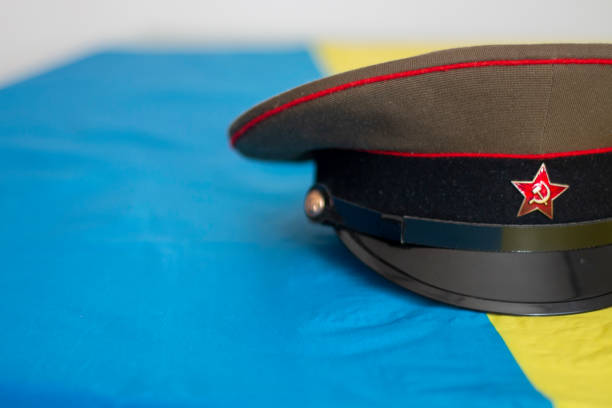istock Ukraine flag with different military objects such as a rifle, a Russian military hat, a map or a police defense 1473952866