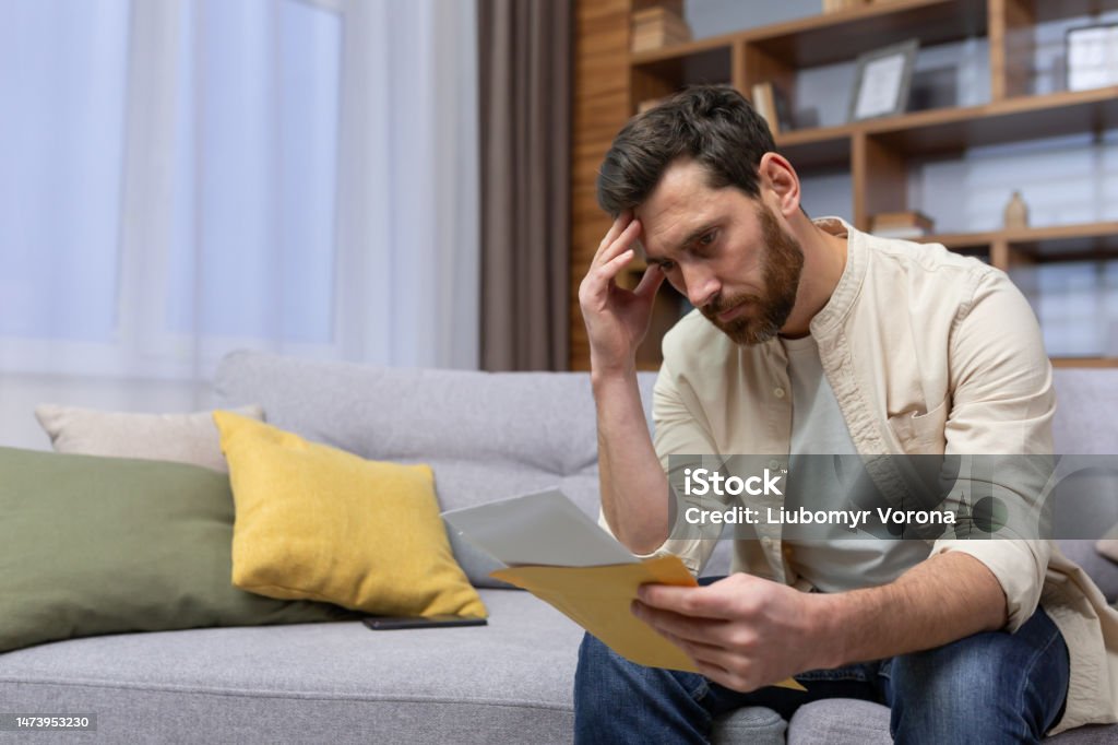 Imponerende syreindhold vidne Upset Man At Home Sitting On Sofa Reading Letter With Bad News Notification  In Envelope Opening Unhappy In Living Room And Sad Stock Photo - Download  Image Now - iStock