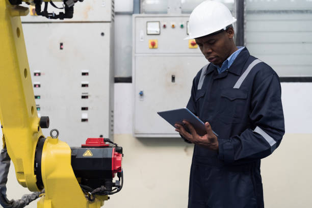 istock Automated manufacturing industries Male engineer worker maintenance industrial automatic robotic arm machine for manufacturing in workshop. Male technician worker repair robotic arms in factory 1473953420