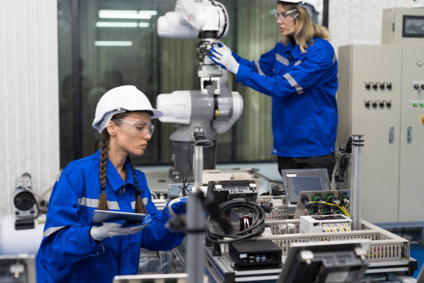 istock Female engineer working, checking electronic circuit motherboard and mechatronics in workshop. Female technician setup electronic circuit board of computer. Innovative technology concept 1473953446