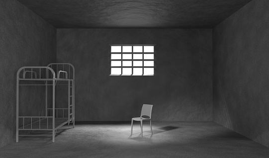 Dark prison cell with bunk bed, chair and metal bars on window 3d render. Realistic interior of jail room with concrete walls and sunlight on floor. Cage for criminals and prisoners. 3D illustration