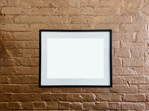 Blank frame on brick walll.