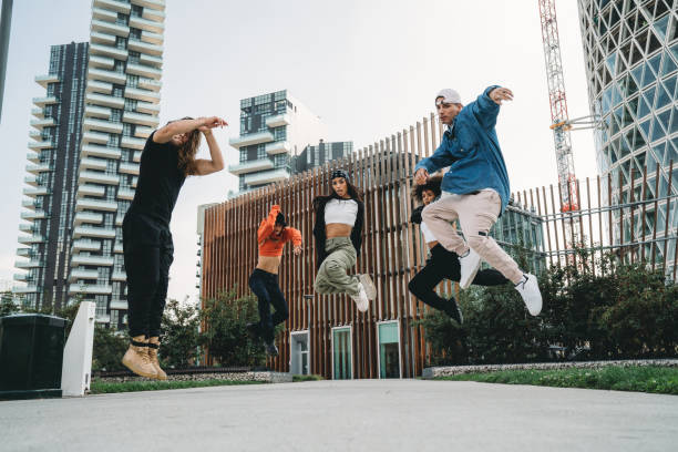 istock Five cool friends are jumping in a modern location 1473957522