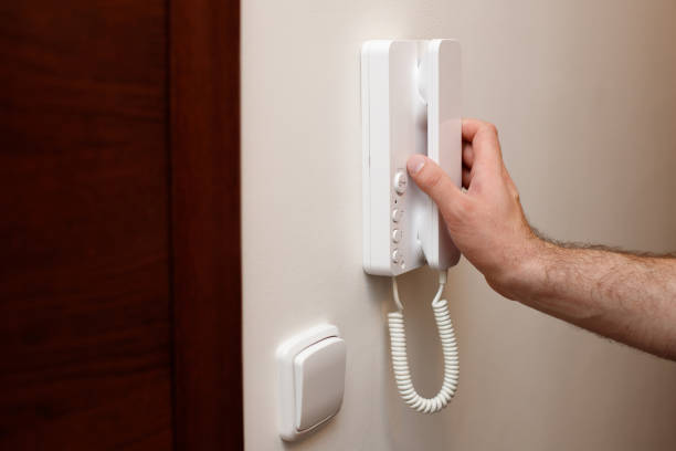 istock close-up of a man answering the call to the intercom 1473957564