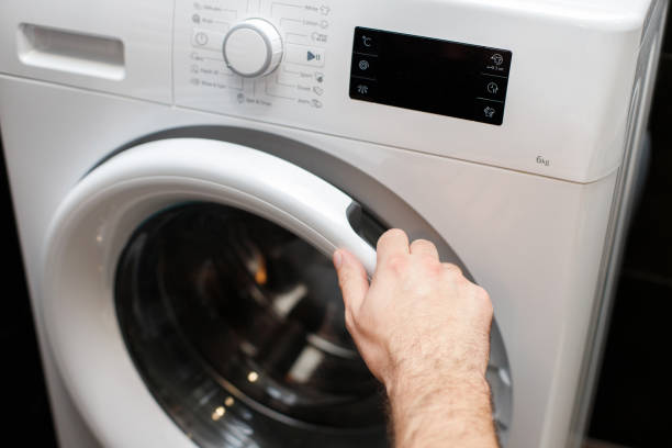 istock open the washing machine door close-up 1473957604