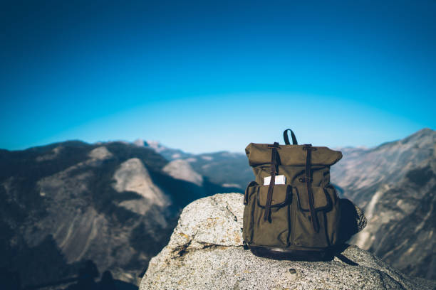 istock Touristic backpack on top of mountain in sunlight 1473957735