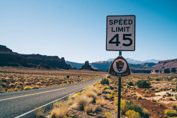 istock Empty road with speed limit sign on roadside 1473957743