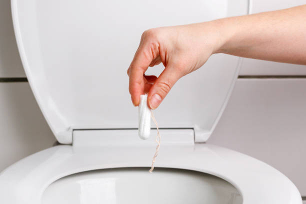 istock someone throws a tampon down the toilet 1473957748