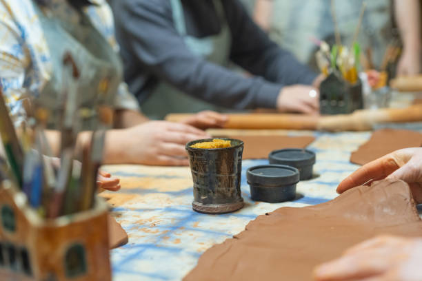 istock Close up of human hands making a clay mug. Pottery teaching class. Potter makes dishes from clay, ceramics. 1473958361