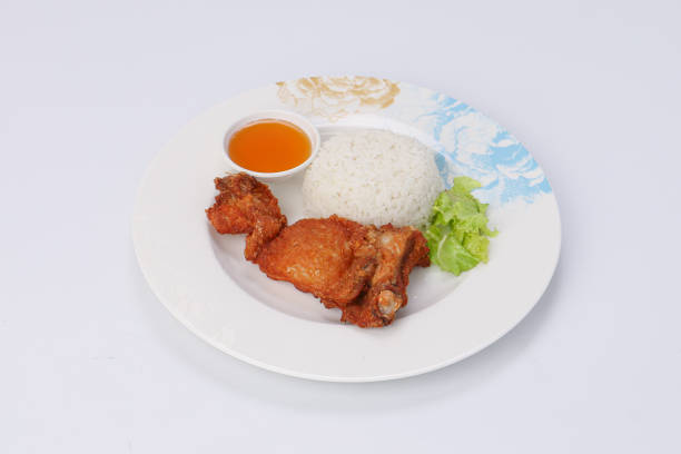 Fried chicken with rice and sweet sauce in a dish on isolate background.