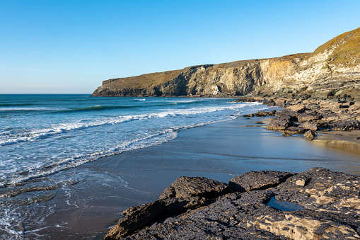Trebarwith Strand Beach in Cornwall at low tide revealing rock formations and rock pools