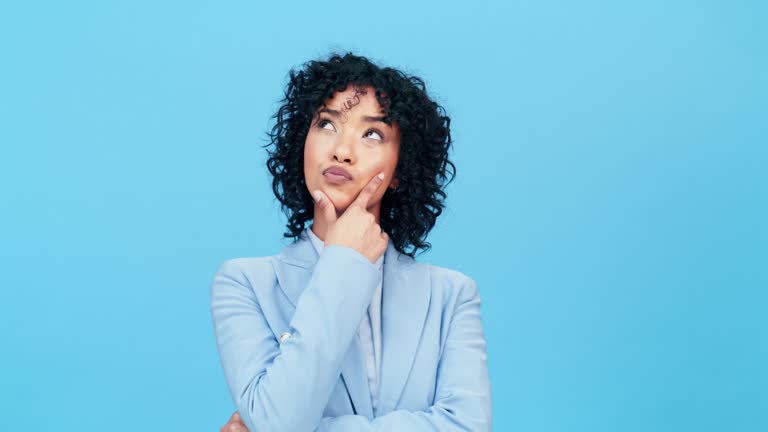Thinking, confused and black woman in studio on mockup, advertising and space on blue background. Doubt, unsure and hands on face of girl contemplating, decision and emoji while pensive and isolated