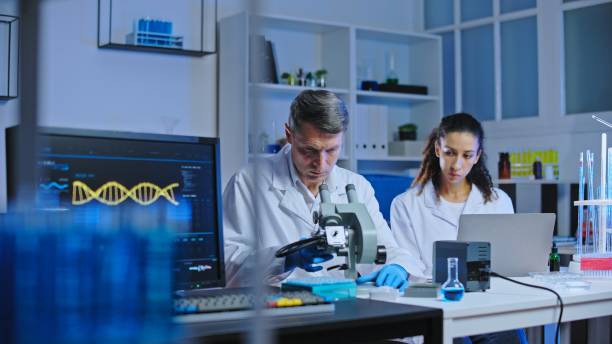 istock Researchers preparing biological sample to study under microscope, pharmaceutical drug development 1473961985