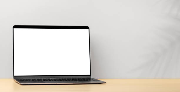 istock Laptop with blank screen on wooden table 1473962358