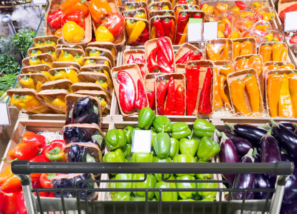 buying vegetables(cucumbers, peppers, tomatoes) at the market