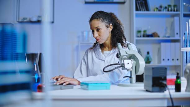 istock Focused woman laboratory technician working on computer, doing scientific research 1473962637