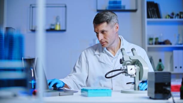istock Laboratory scientist typing test results on laptop, checking with previous research 1473962638