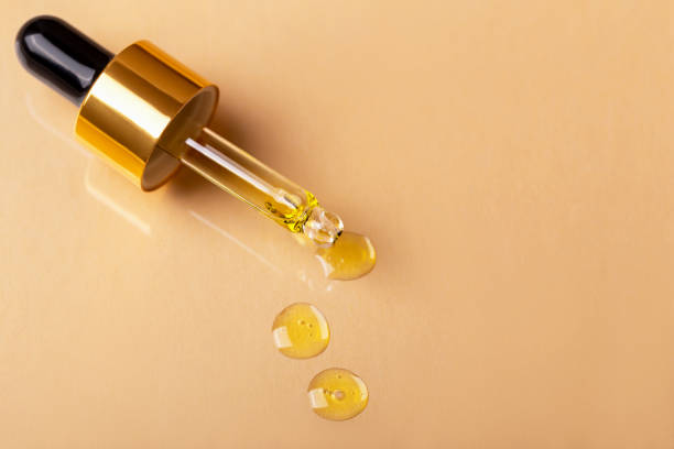 istock Pipette with yellow liquid is on beige background 1473963876