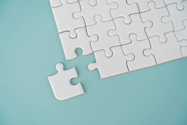 istock White jigsaw puzzle background for business concept of strategy solution 1473964010