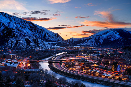 Glenwood Springs at Dusk with Colorado River View - Colorado River flowing through the heart of Glenwood Springs Colorado at dusk during blue hour. Sunset skies.