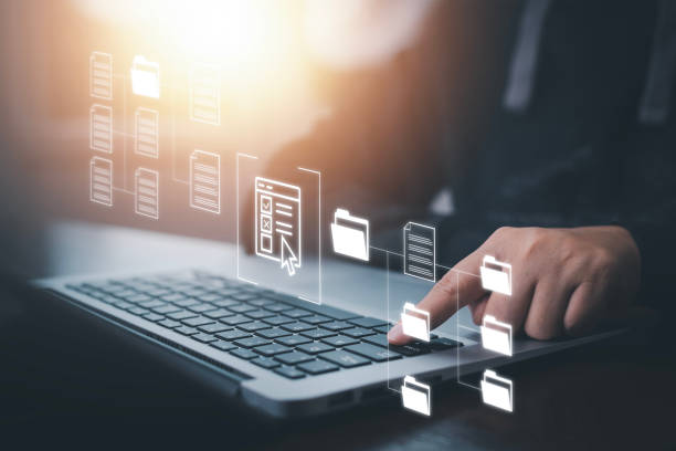 istock Businessman working on laptop with virtual screen. Online documentation database, IT consultant being set up Virtual Document Management System with laptop,Software for archiving corporate files. 1473967083