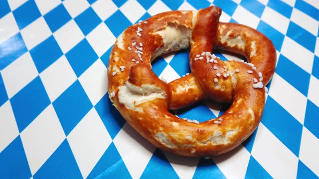 German pretzel on Bavarian white blue rhombus flage background