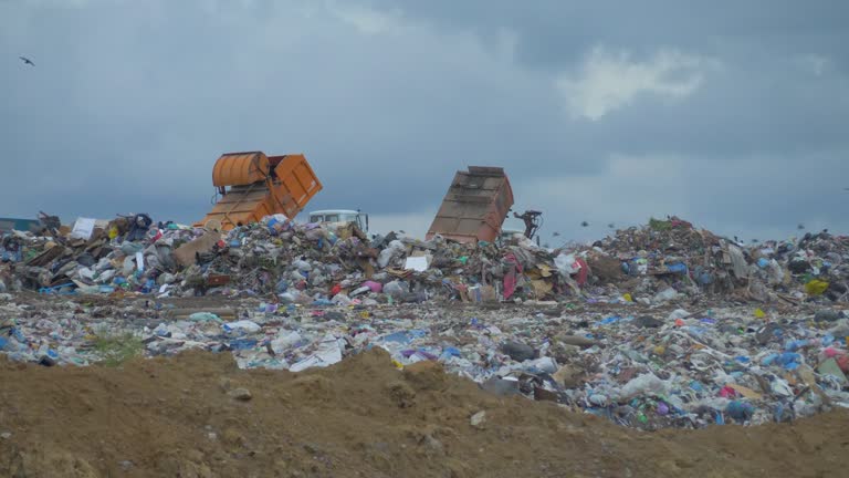 Dump truck works on landfill operation site