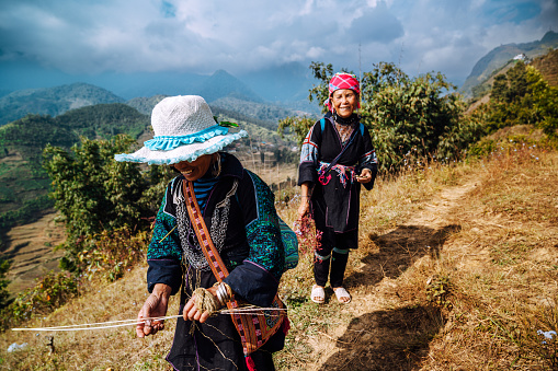 Two indigenous women from Black Hmong Tribe hiking in the mountains near Sapa, North Vietnam