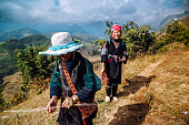 two women from Black Hmong Tribe hiking in the mountains near Sapa, North Vietnam