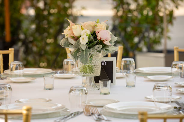 istock Wedding reception or other outdoor festive event. Luxury wedding reception dining table and gold decoration on a table. Table set for a party event or wedding reception. 1473968824