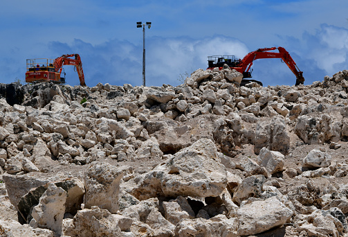 Anibare District, Nauru: phosphate mining continues in Nauru, although on a smaller scale than in the past, when it was crucial for the country's economy. Republic of Nauru Phosphate Corporation (RONPhos / NPC) excavators. Except for a narrow coastal strip, the inner central plateau of the island was covered by phosphate (Nauruit) formed from the droppings of seabirds.
