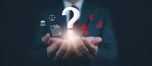 Tax with Ask question online concept, Businessman hold interface question marks tax payment optimization business finance, Concept of searching for an answer, Uncertainty, and problem-solving.