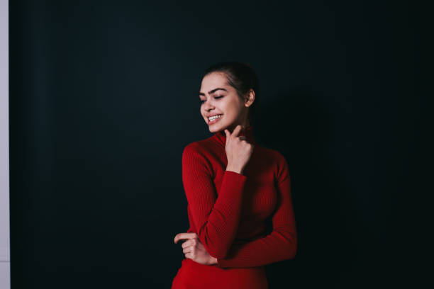 istock Young woman touching chin and smiling 1473971272