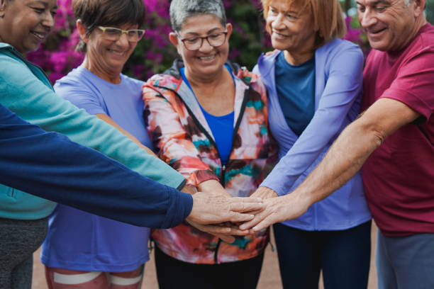 istock Multiracial senior people stacking hands after sport workout outdoor 1473971921