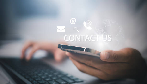 istock Communication and Contact us or Customer support hotline people connect. Hand using a laptop and touching on virtual screen contact icons, email and address, live chat with internet wifi. 1473971991