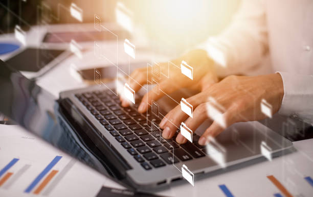 istock Businessman working on laptop with virtual screen. Online documentation database, IT consultant being set up Virtual Document Management System with laptop,Software for archiving corporate files. 1473971992