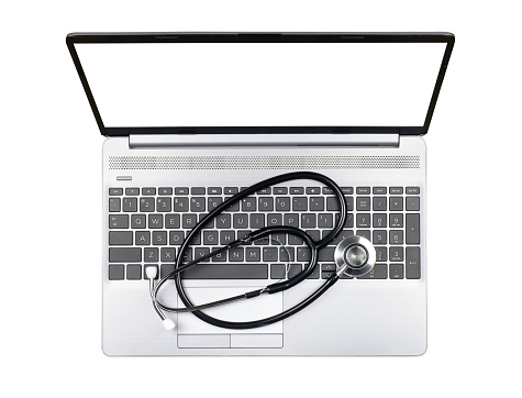 Laptop with blank monitor and stethoscope on keyboard isolated on white background, top view