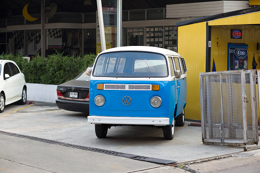 Old blue VW Transporter van without license plate parked on parking lot of second hand car seller shop in Bangkok Ladprao