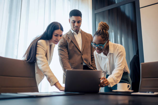 istock Three business persons seen in a meeting room during working hours 1473986701
