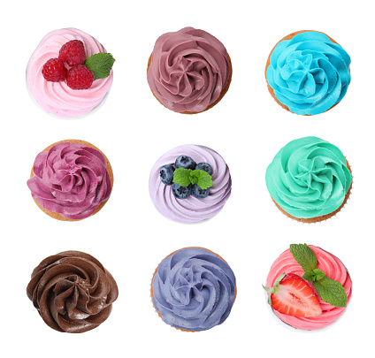 Set of colorful birthday cupcakes on white background, top view