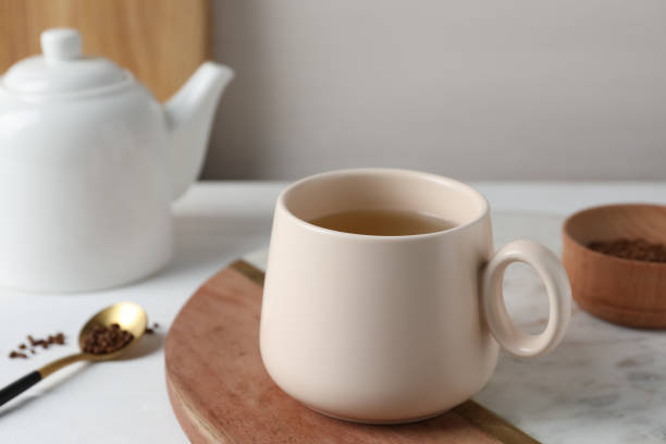 istock Cup of aromatic buckwheat tea and granules on white table 1473988288