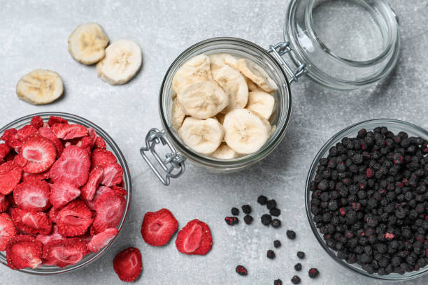 Many different freeze dried fruits on light grey table, flat lay