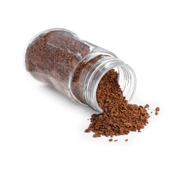 istock Glass jar and scattered instant coffee isolated on white 1473989450