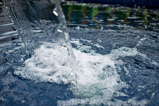 Close-up spray of a fountain, summer sunny day, toned, effect of strong vignetting