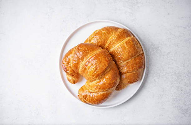 istock Fresh croissants in a plate for breakfast 1473990043